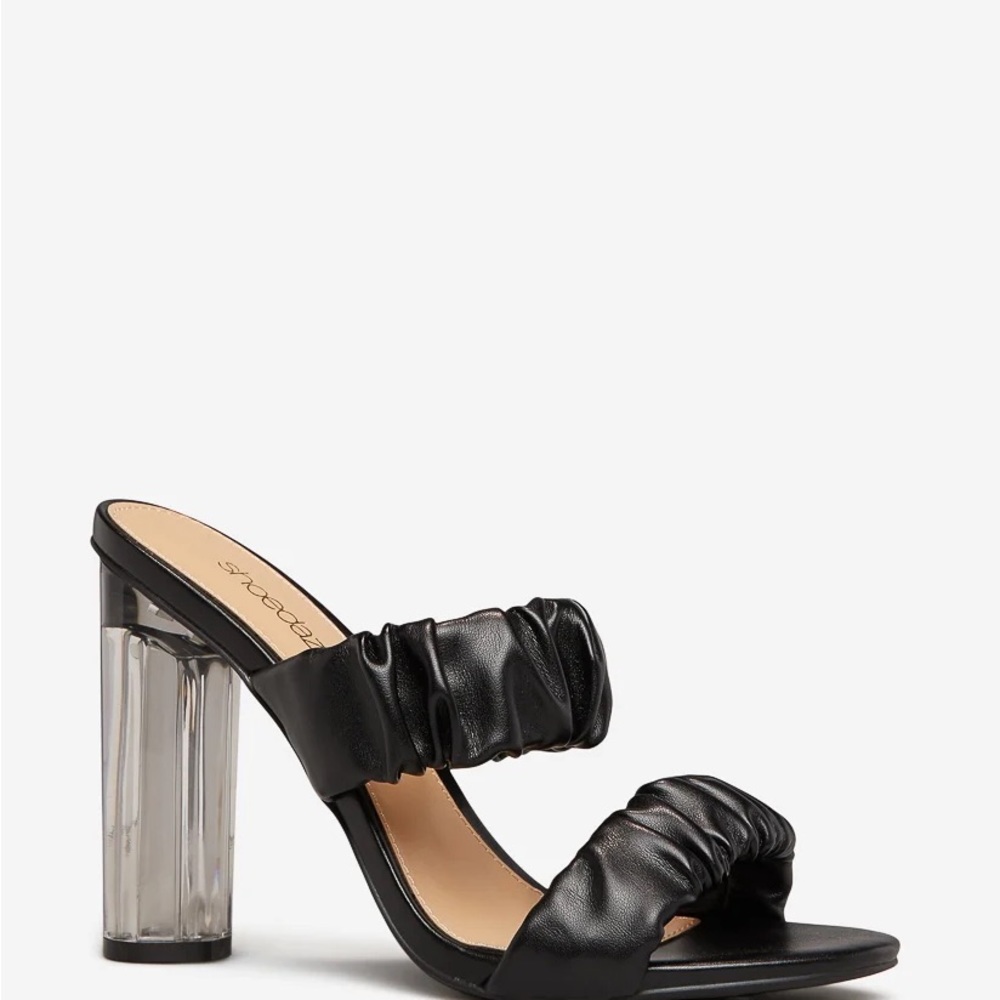 Slip on sandal featuring a lucite block heal and ruched straps.